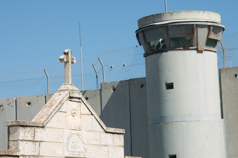 A stone cross appears on a Palestinian building near the Israeli separation wall dividing the West Bank town of Bethlehem, April 29, 2014.